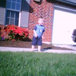 Ezra smiling in front of the house